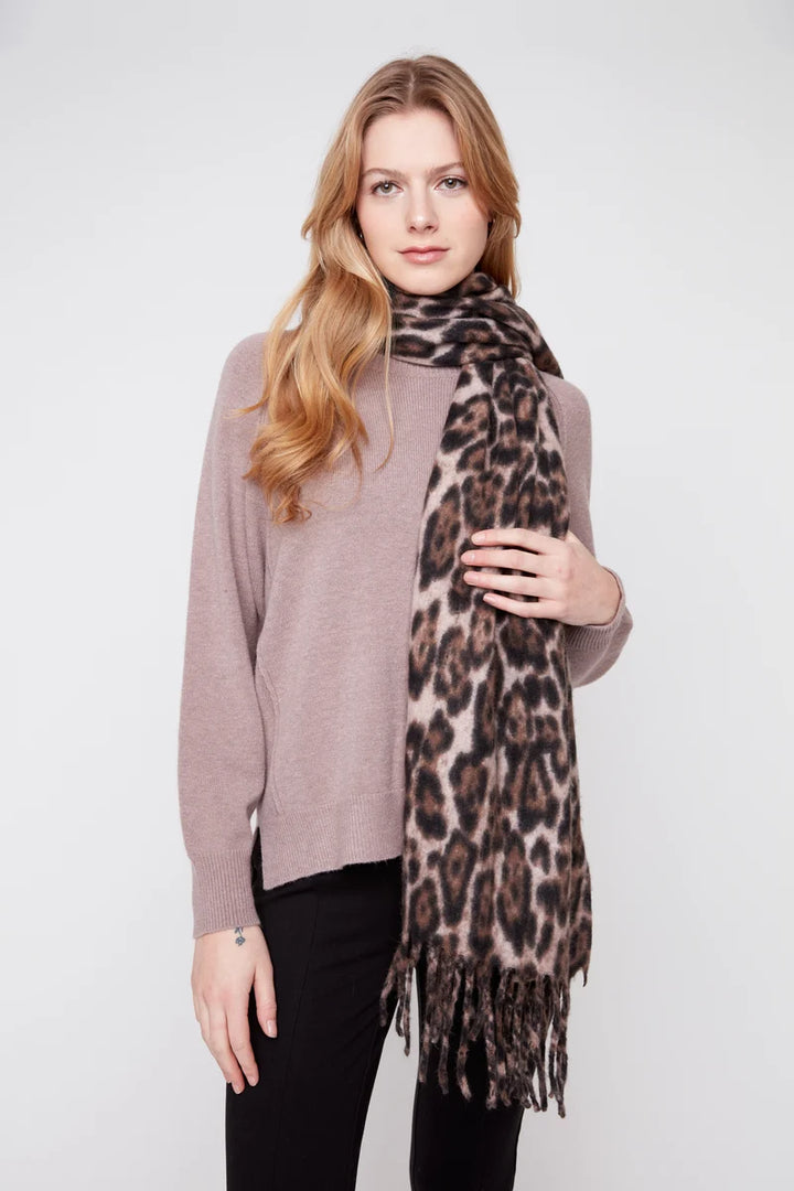 Woman wearing a leopard print scarf on a white background