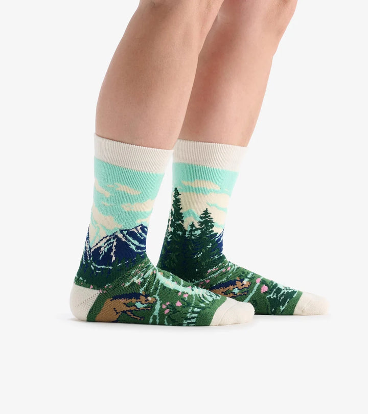 Socks with nature design worn by a person on a white background