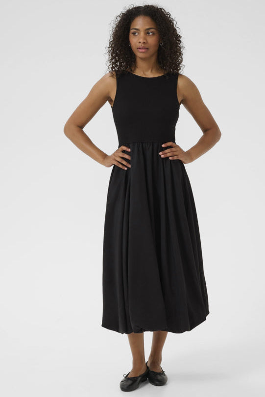 Woman wearing a black sleeveless dress on a white background