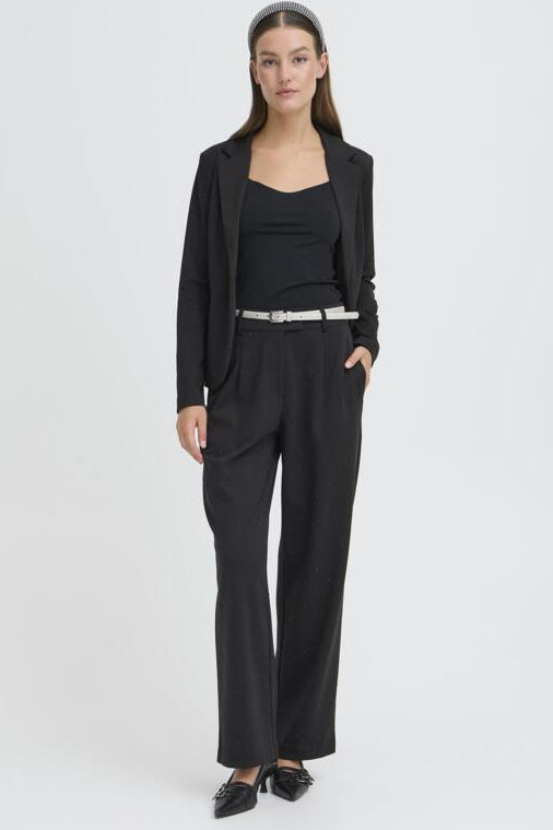 Woman wearing a black suit with a white background