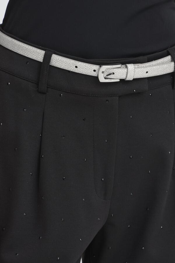 Black pants with a patterned belt and buckle