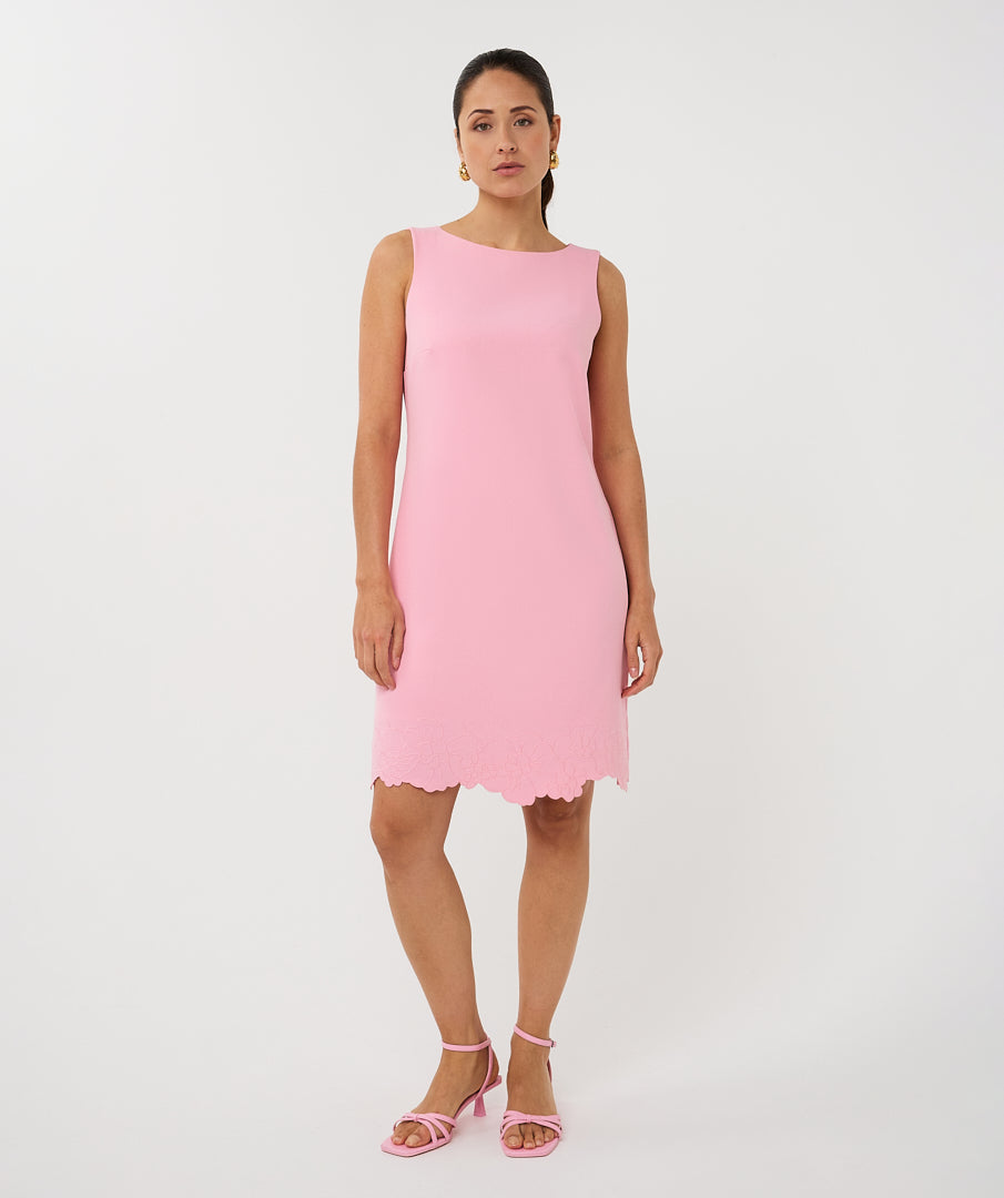 Woman wearing a pink dress on a white background