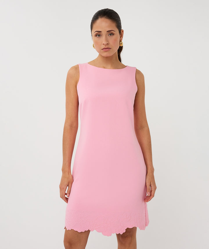 Woman wearing a pink dress on a white background