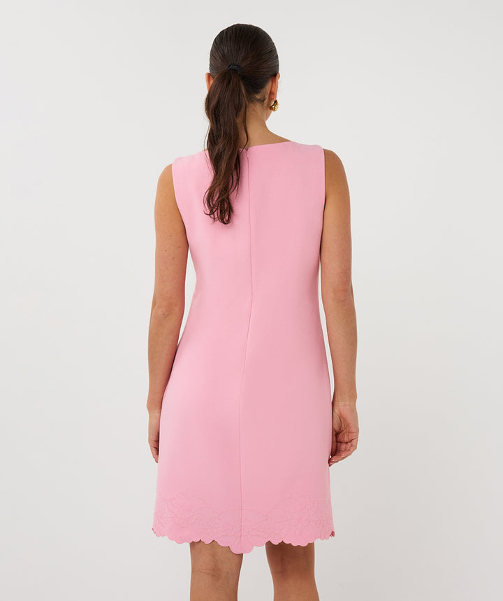 Pink dress worn by a person on a white background