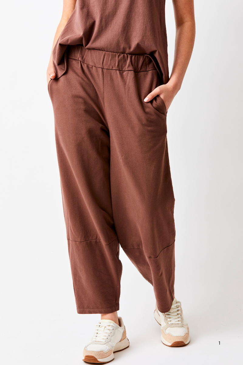 Brown pants worn by a person on a white background