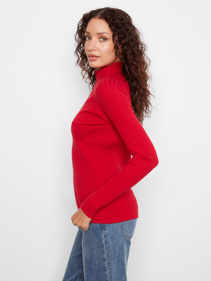 Woman wearing a red sweater and blue jeans on a white background