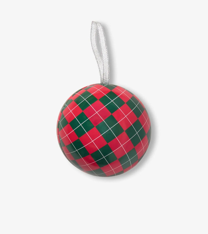 A round Christmas ornament with a red and green argyle pattern and a white hanging ribbon, shown against a light gray background.
