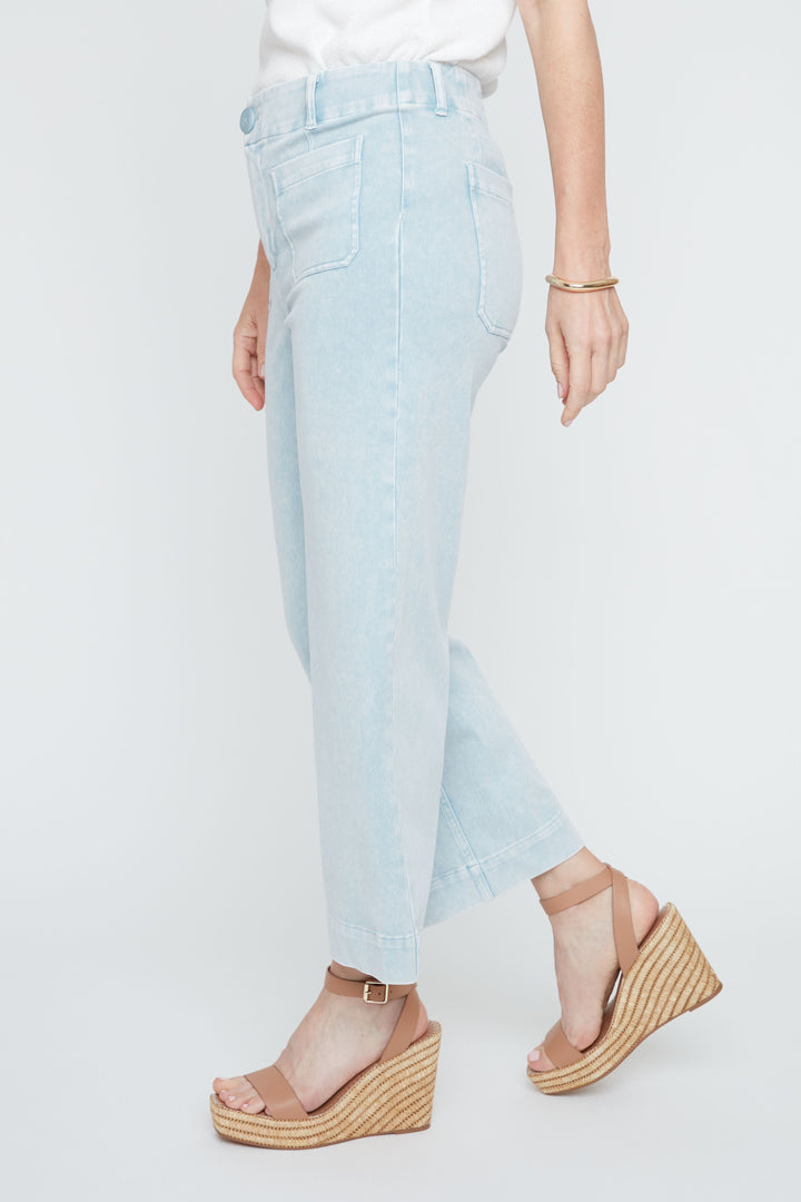 Light blue jeans worn by a person on a white background