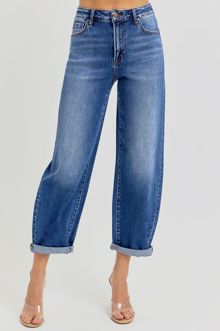 Blue jeans worn by a person on a light gray background