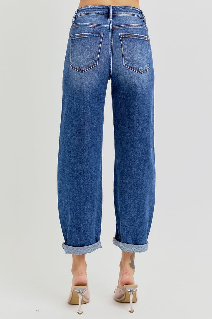 Blue jeans worn by a person on a light gray background