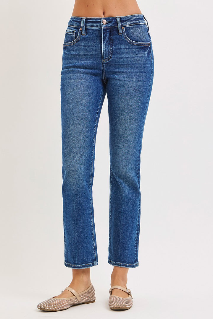 Blue jeans worn by a person on a light gray background