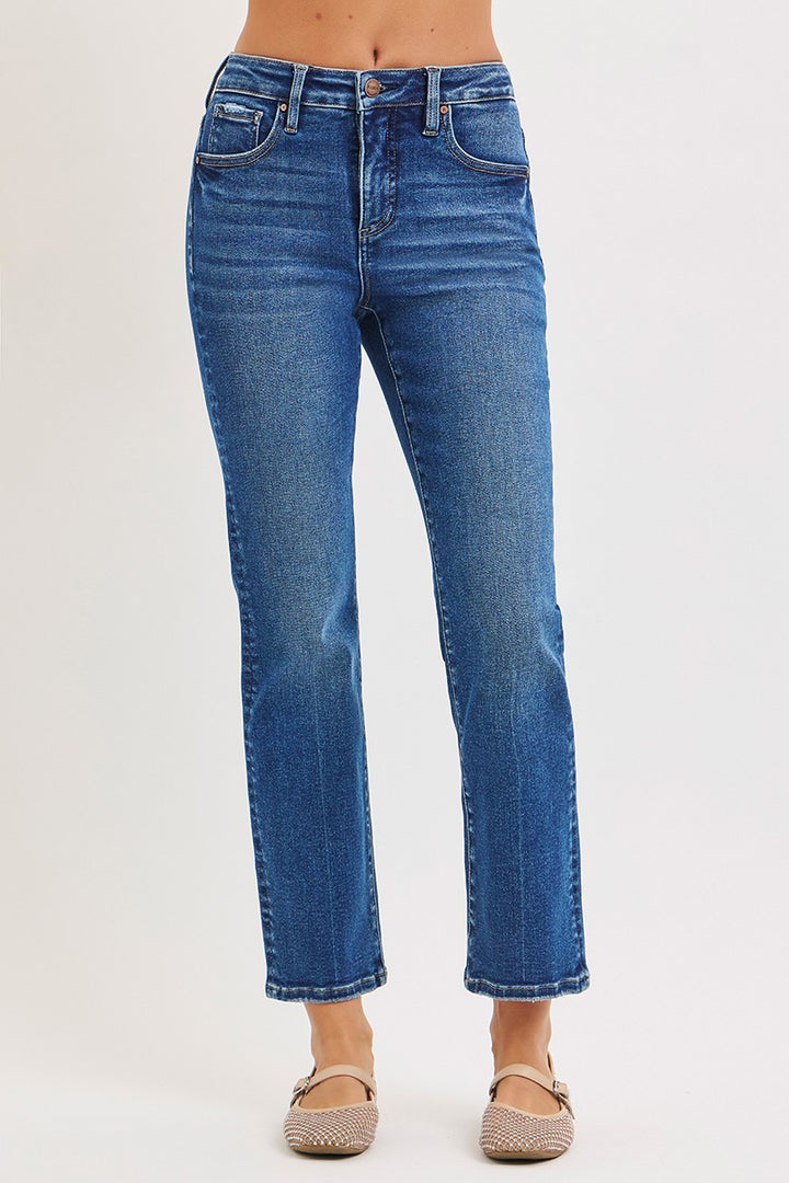 Blue jeans worn by a person on a white background