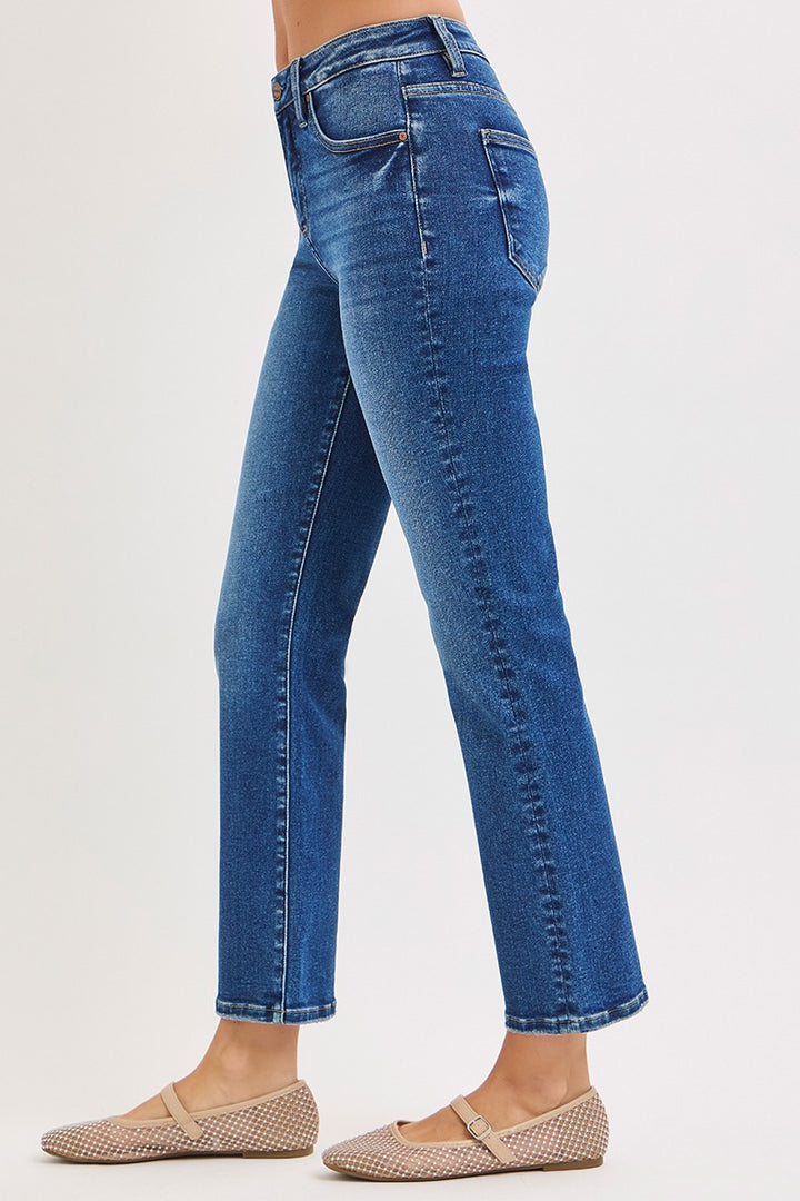Blue jeans worn by a person on a white background