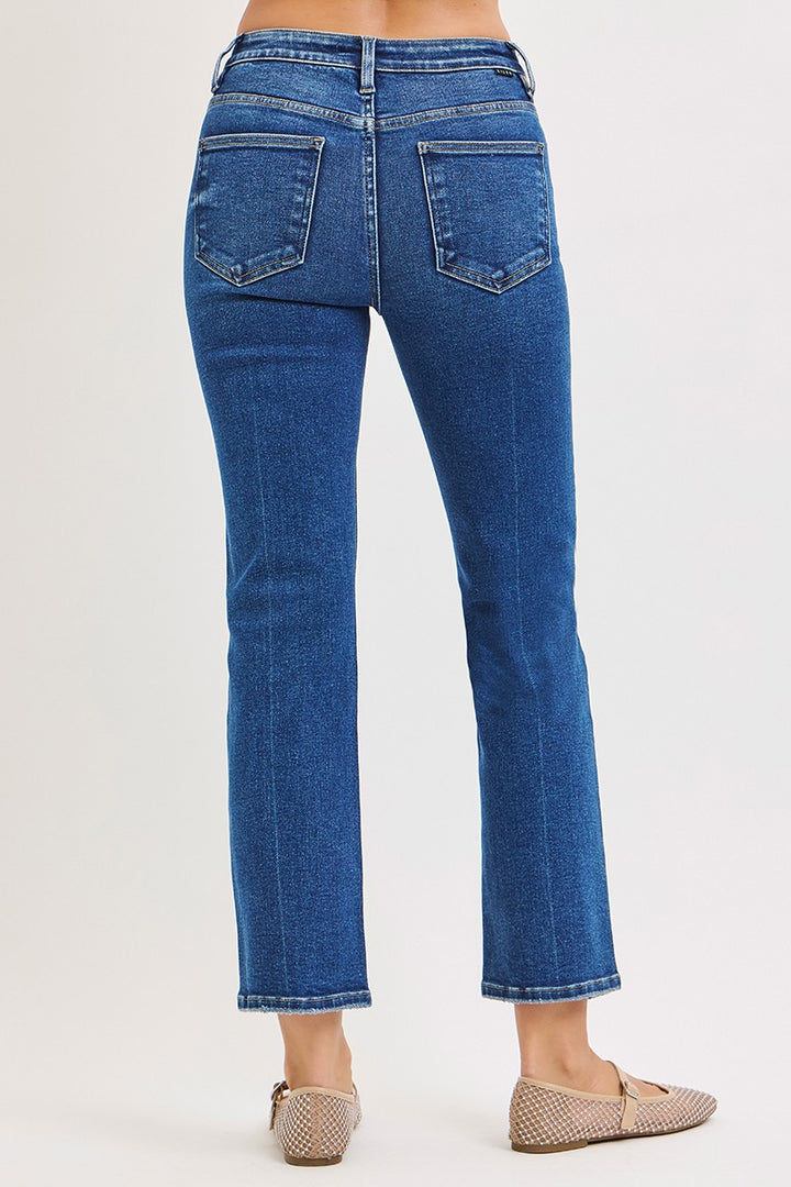 Blue jeans worn by a person on a white background