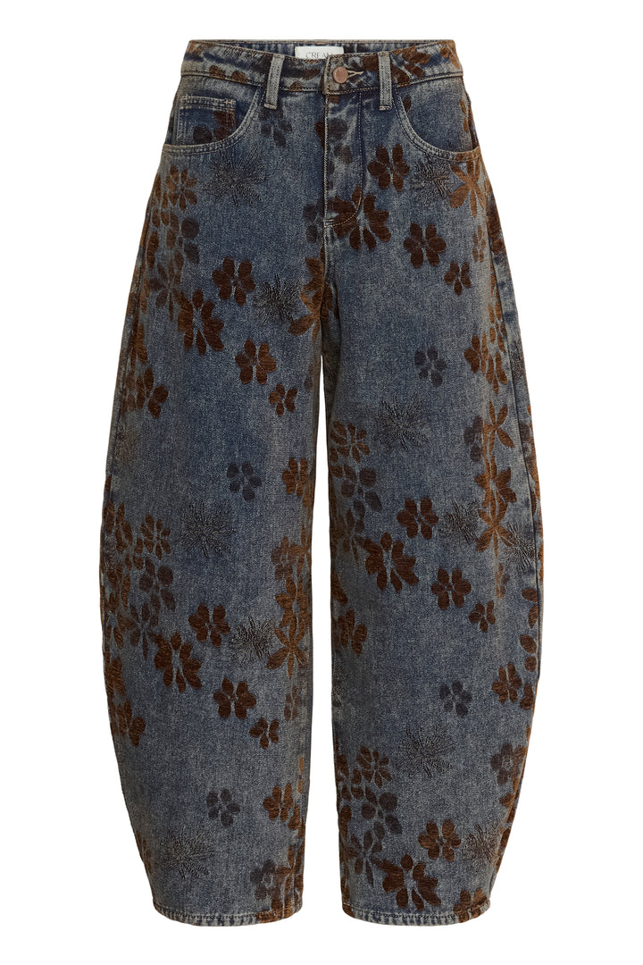 Wide-leg cropped jeans in a washed blue denim-like fabric with an allover dark brown floral pattern, shown against a plain white background.