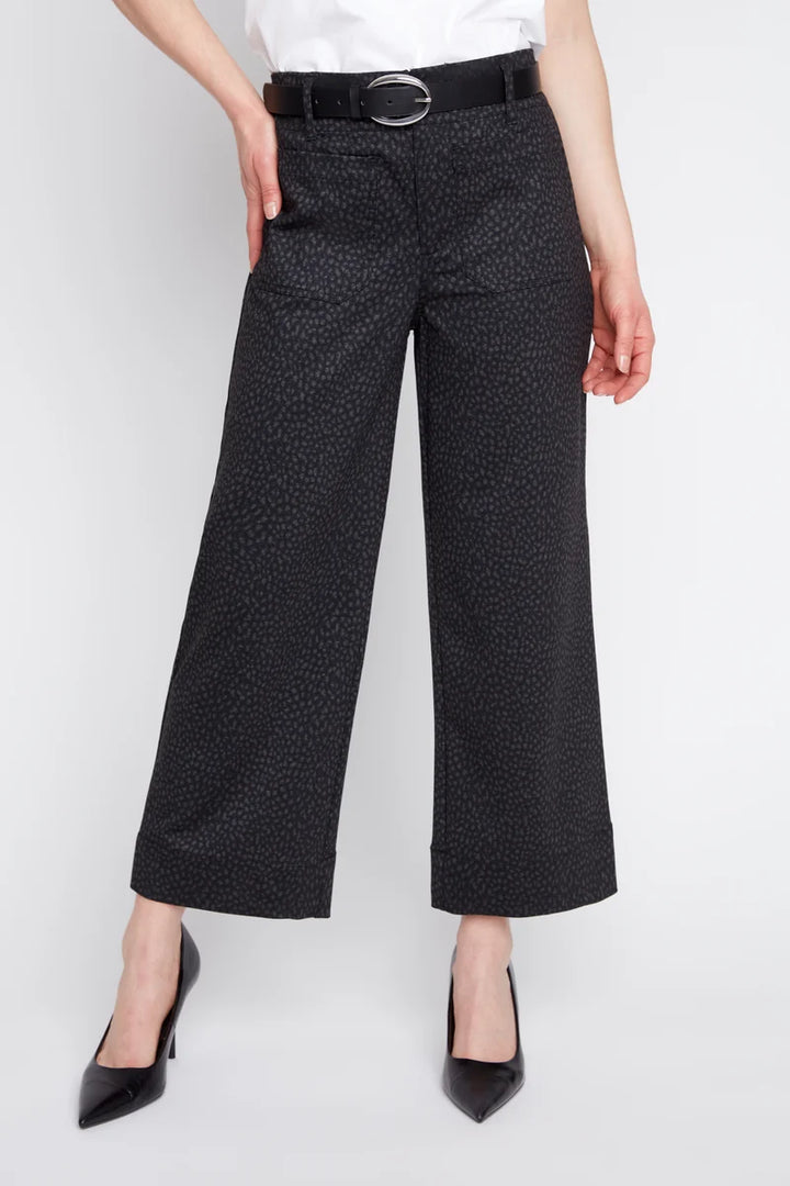 Black cropped wide-leg trousers with a subtle textured pattern, styled with a black belt, white top, and black pointed-toe heels on a model.