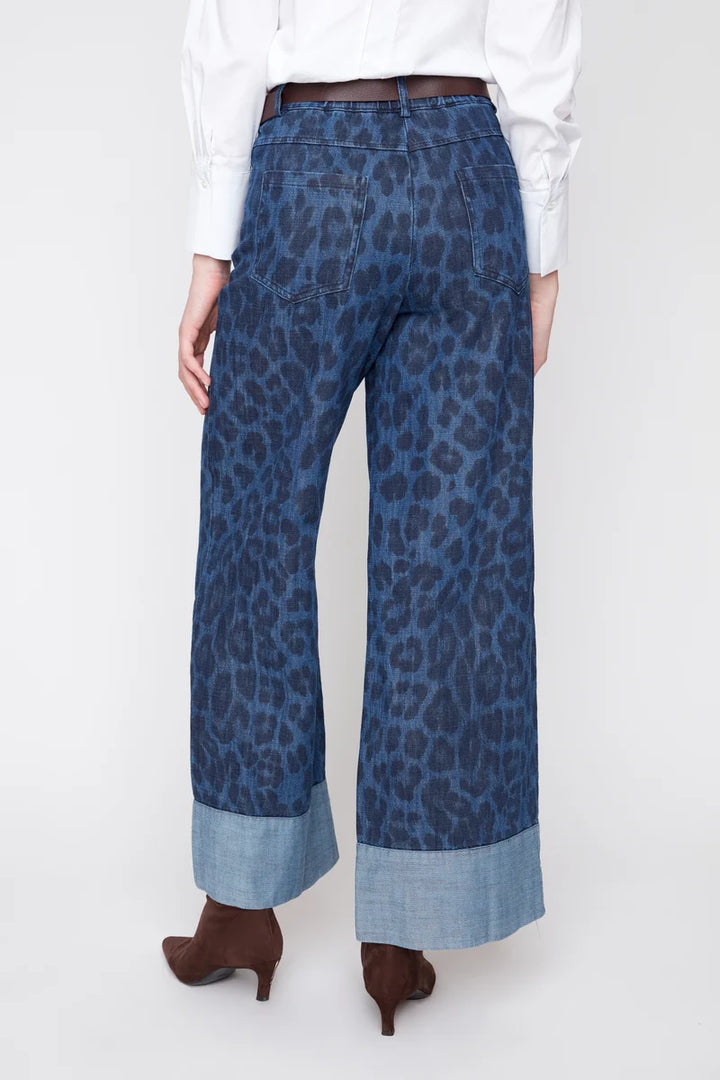Blue leopard print pants worn by a person on a white background