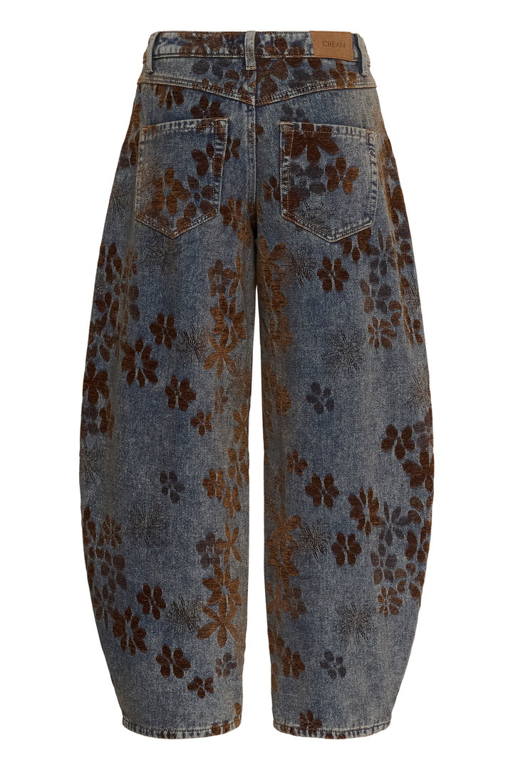 Wide-leg cropped denim pants with a brown floral pattern, shown from the back on a white background.