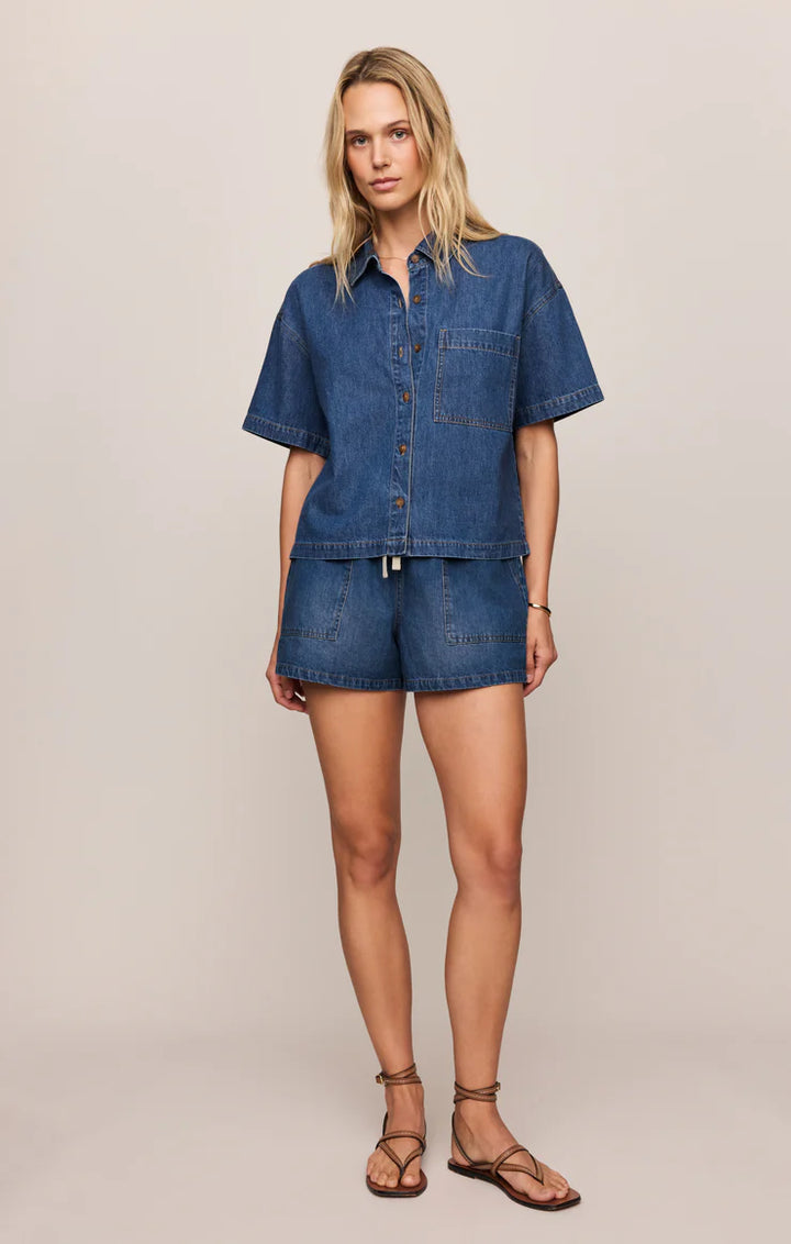 Woman wearing a denim outfit on a plain background