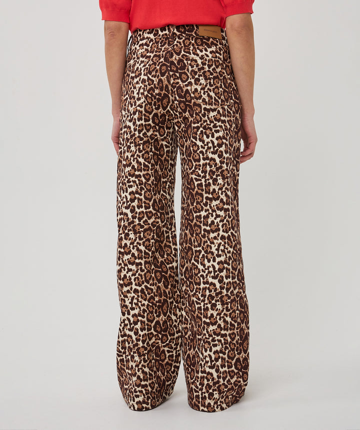 Leopard print pants worn by a person on a plain background