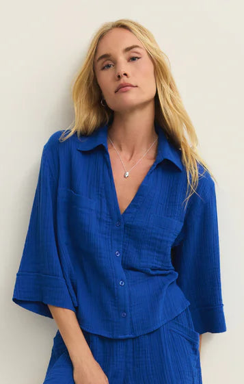 Woman wearing a blue outfit against a white background