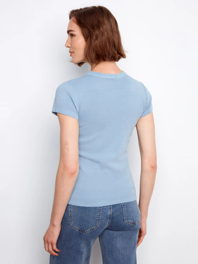 Person wearing a light blue t-shirt and jeans against a white background