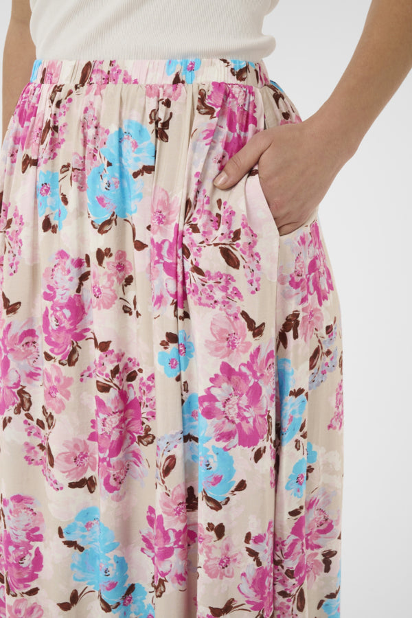 Floral patterned skirt with pink, blue, and brown colors on a white background