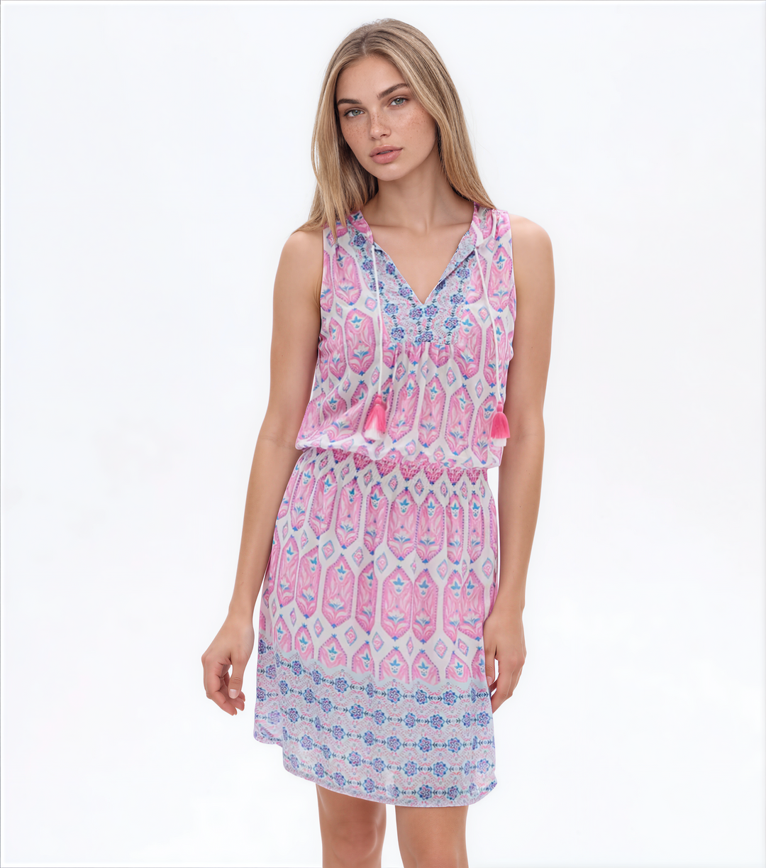 Woman wearing a pink and white patterned dress on a white background