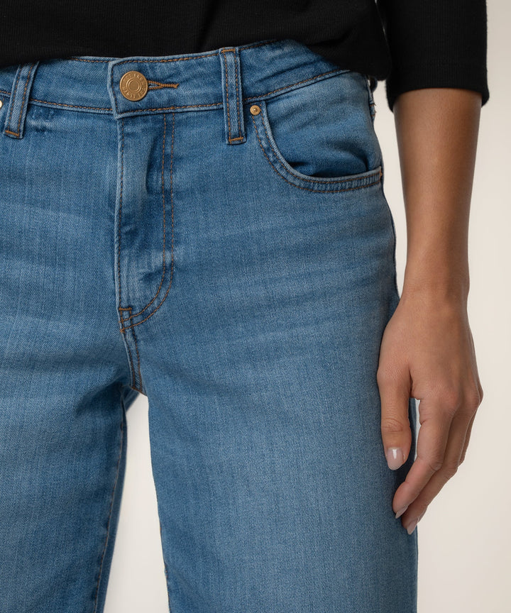 Close-up of blue jeans with a neutral background