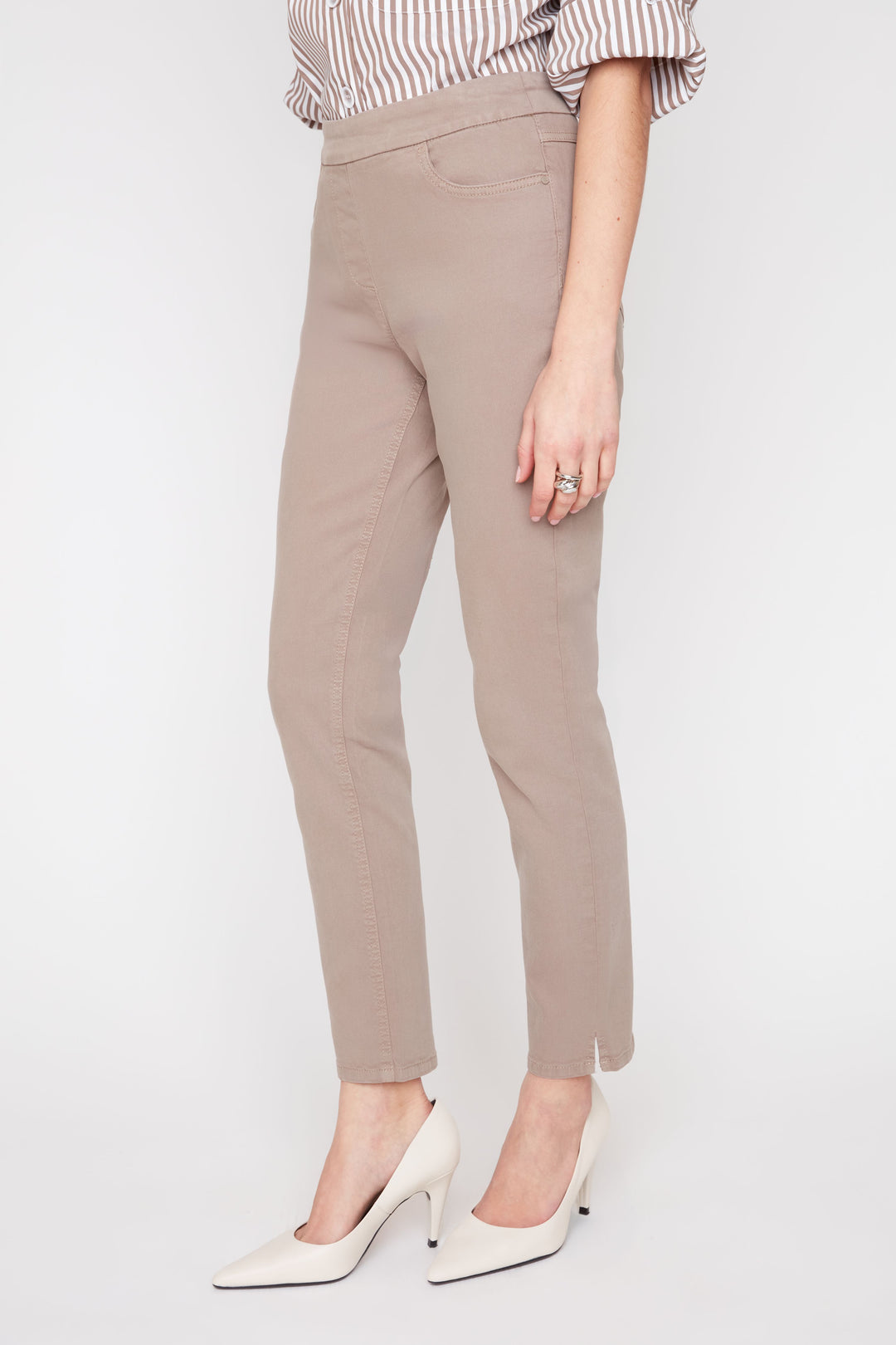 Beige pants worn by a person on a white background