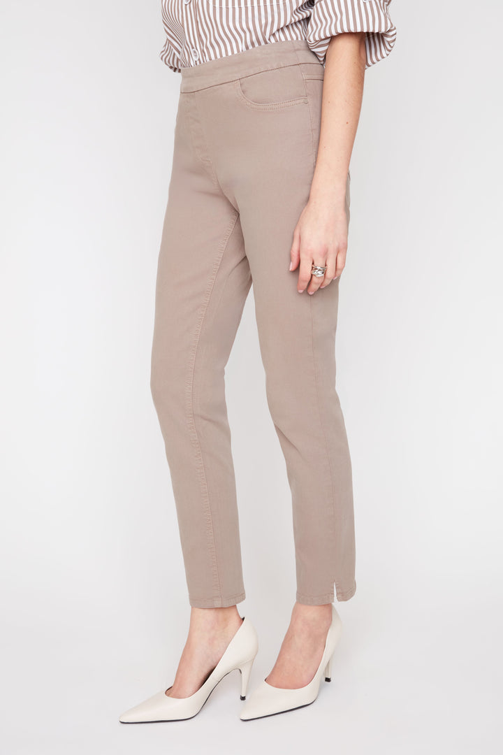 Beige pants worn by a person on a white background