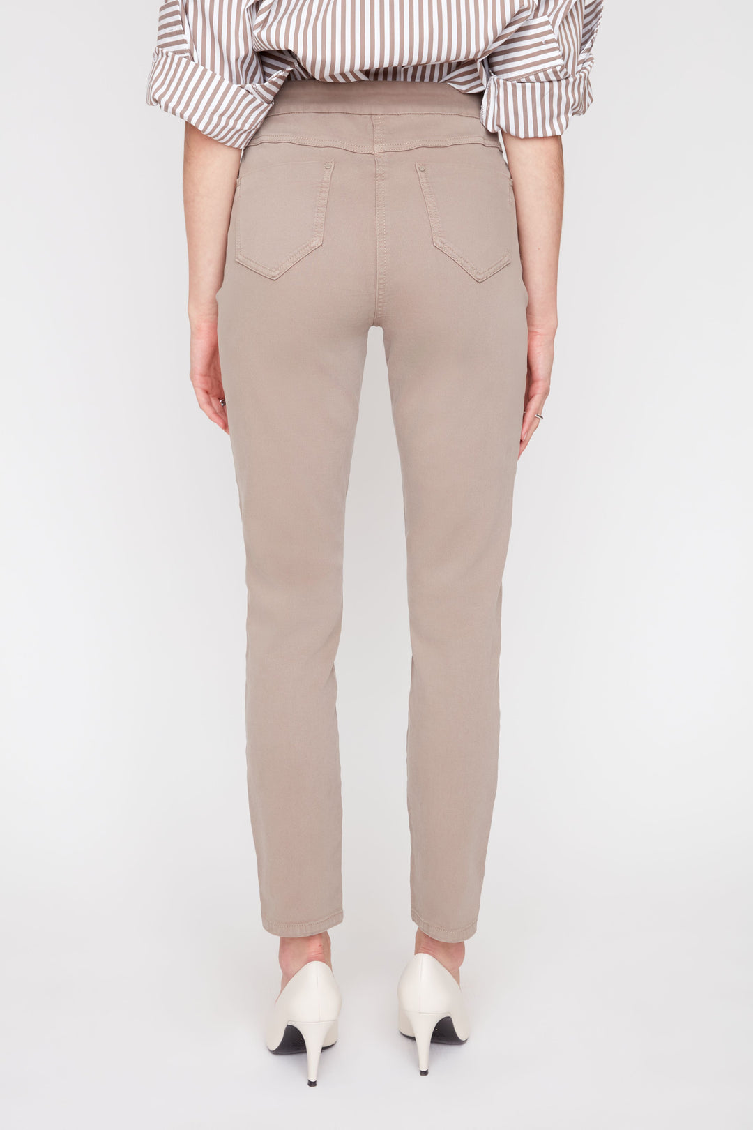 Beige pants worn by a person on a white background