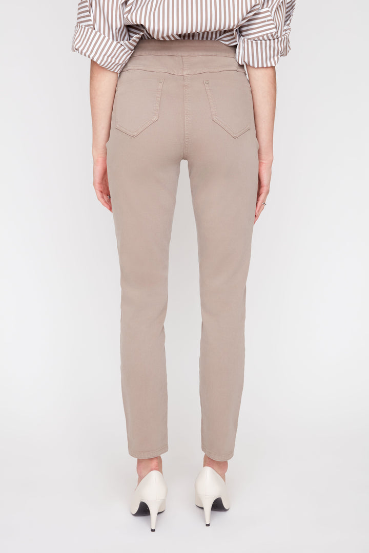 Beige pants worn by a person on a white background