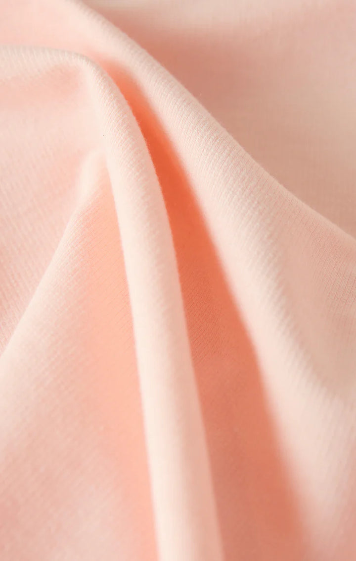 Close-up of soft pink fabric with folds