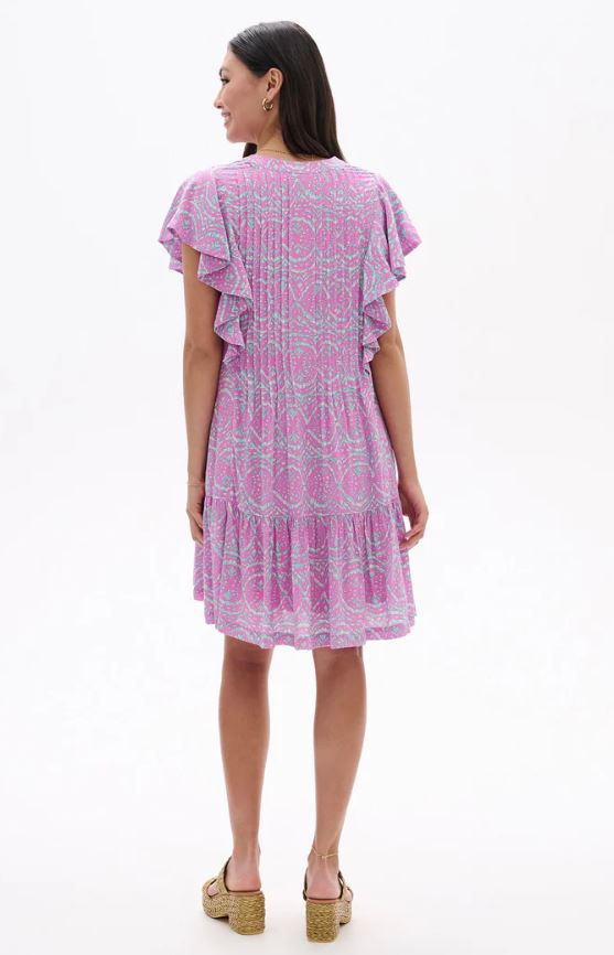 Woman wearing a pink patterned dress on a white background