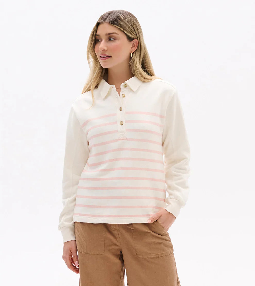 Woman wearing a white and pink striped long-sleeve shirt on a white background