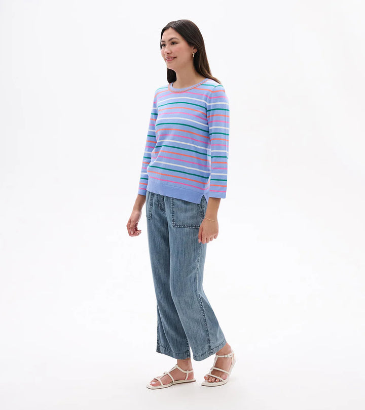 Woman wearing a striped sweater and jeans on a white background