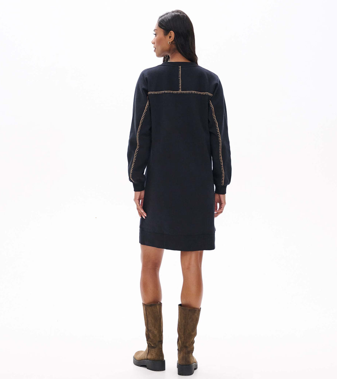 Woman wearing a black dress with brown accents on a white background