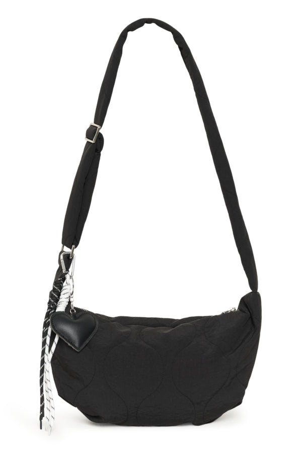 Black quilted handbag with a strap on a white background