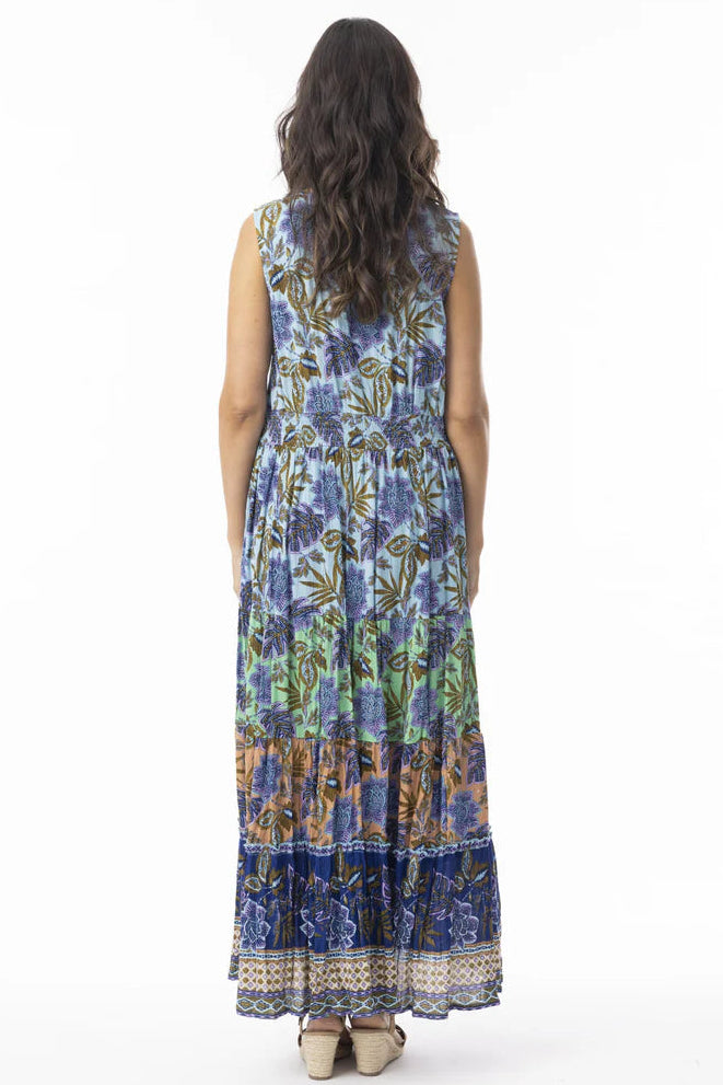 Woman wearing a sleeveless floral dress on a white background