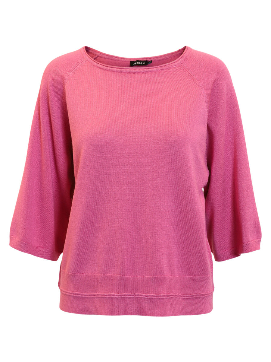 Pink sweater with a brand label on a white background