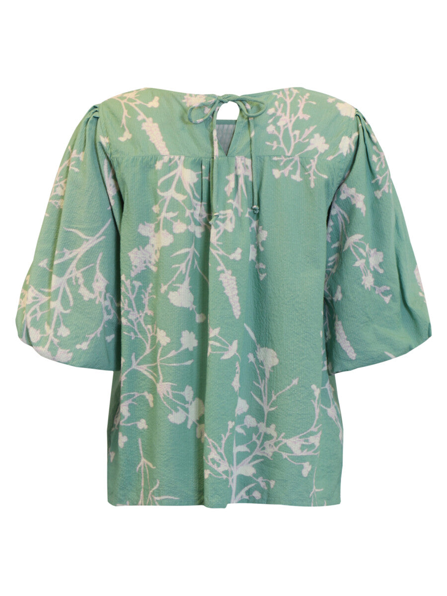 Green floral blouse on a white background