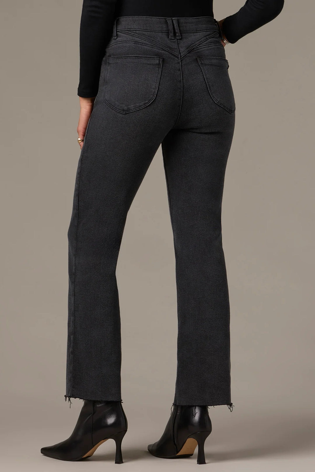 Dark gray pants worn by a person on a neutral background