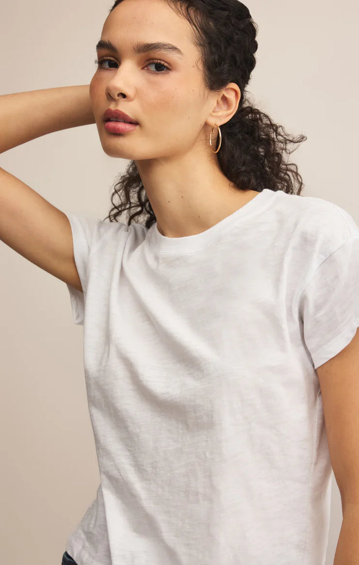 Woman wearing a plain white t-shirt against a neutral background