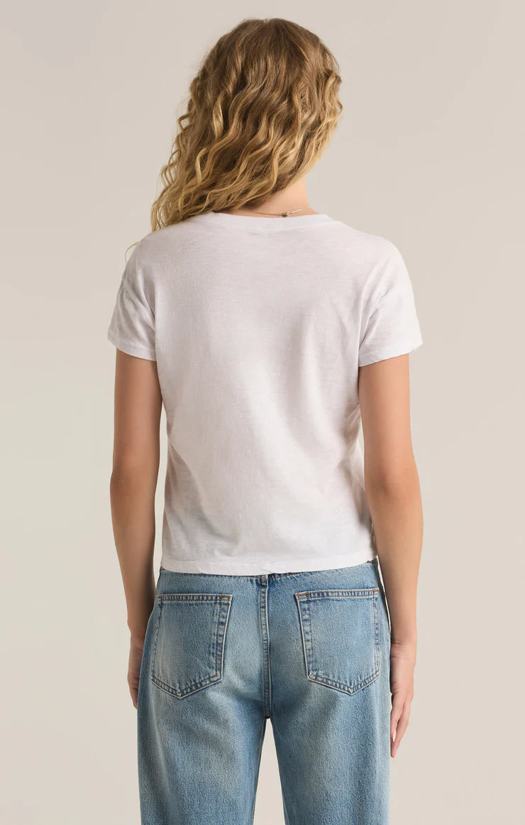 Person wearing a plain white t-shirt and blue jeans on a neutral background