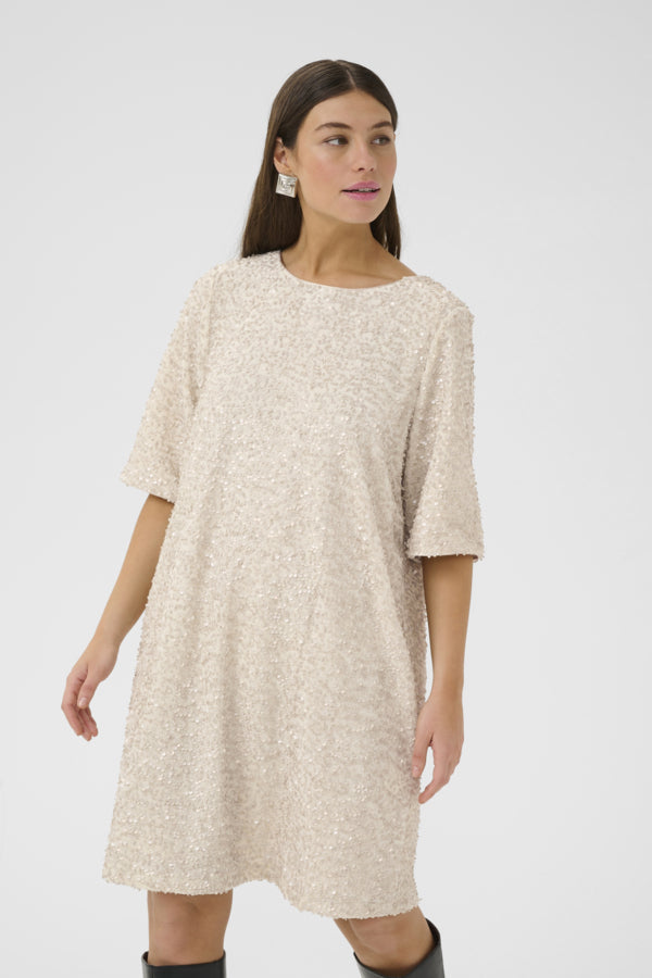 Woman wearing a beige dress on a white background
