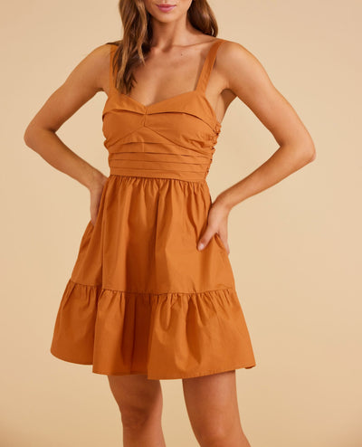 Look and feel amazing in this beautiful Serano Mini Dress in Ginger! The fabric and adjustable straps ensure a perfect fit, while the horizontal pleats and flared hem create a timeless and flattering silhouette. The elastic back and side zip make it easy to slip on and off, so you'll be ready for any special occasion!  shell 100% cotton, lining 100% viscose