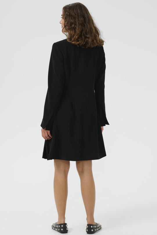 Person wearing a black dress on a white background
