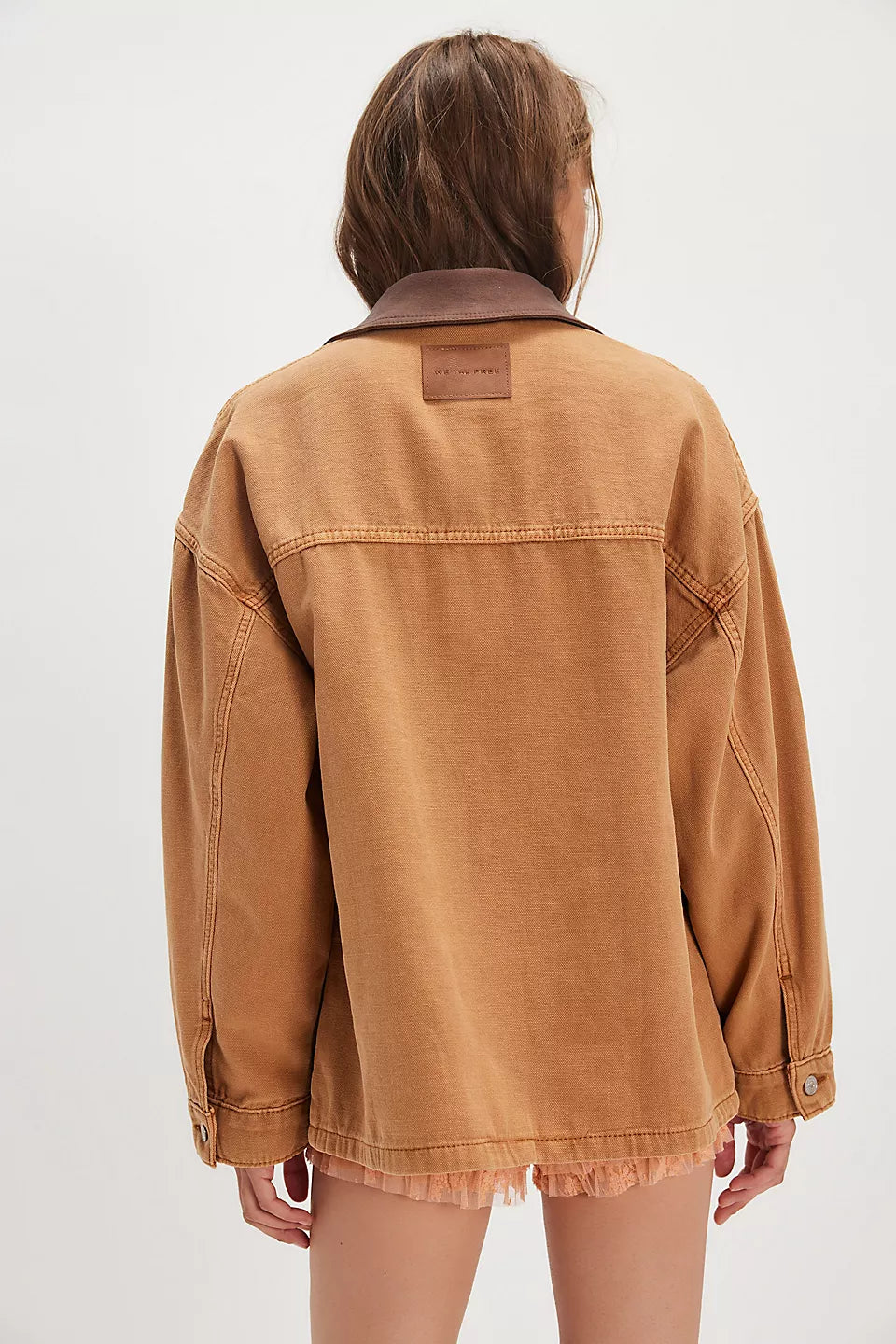 Person wearing a brown jacket on a white background