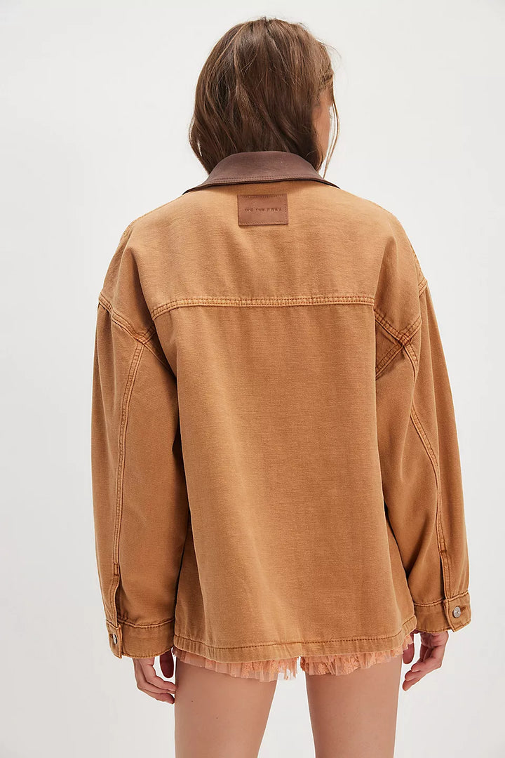 Person wearing a brown jacket on a white background